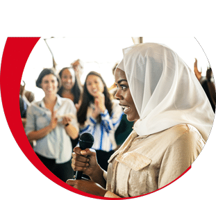 Woman speaking into a microphone during an inclusive theological education event at Chicago Theological Seminary