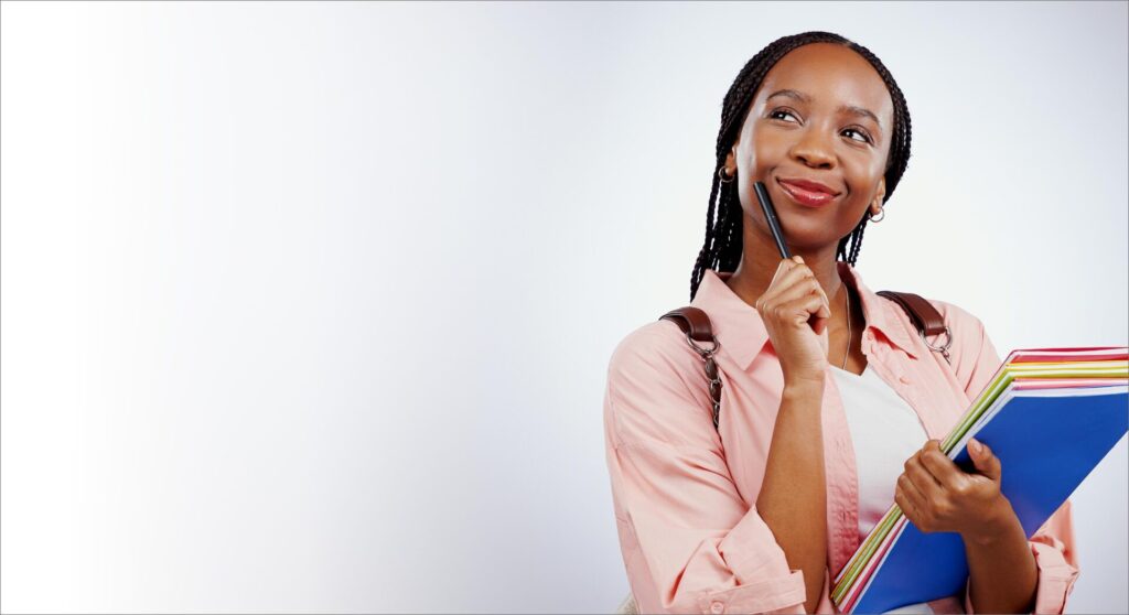 Woman thoughtfully holding books during her theological studies